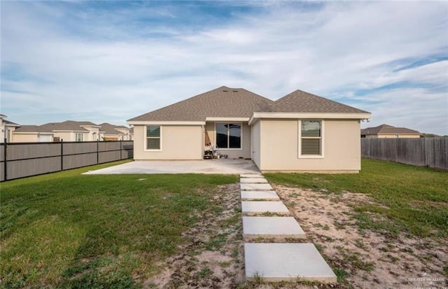 rear view of property with a patio and a lawn