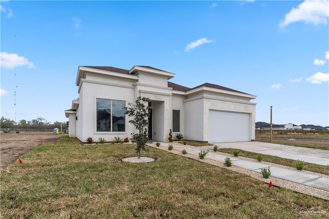 view of front of house with a garage and a front yard