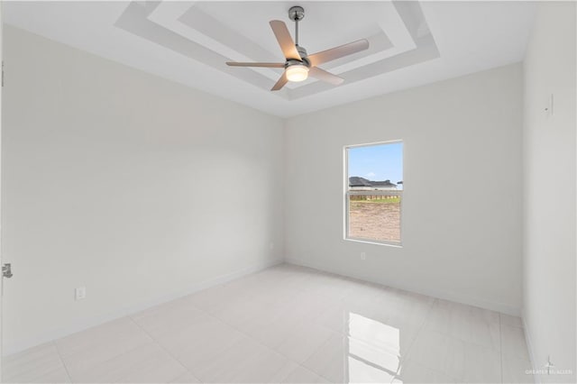 unfurnished room with a tray ceiling and ceiling fan