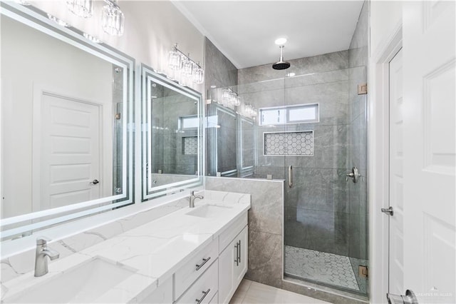 bathroom featuring a shower with door and vanity