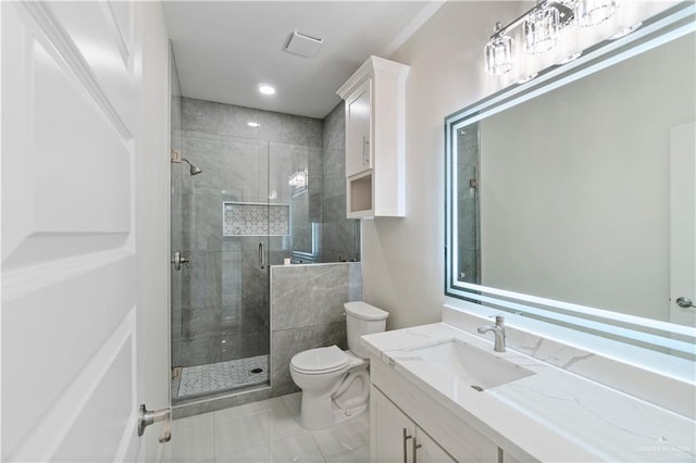 bathroom featuring toilet, a shower with door, and vanity