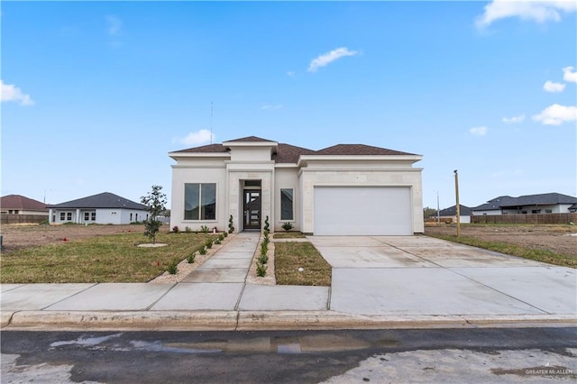 view of front of property featuring a front lawn and a garage