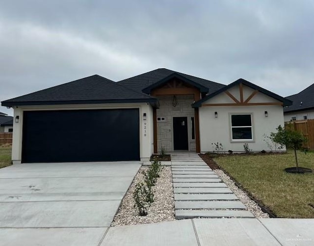 ranch-style home featuring an attached garage, concrete driveway, and a front yard