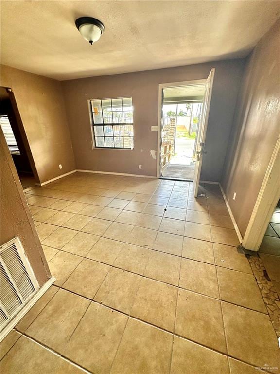 foyer entrance with light tile patterned floors