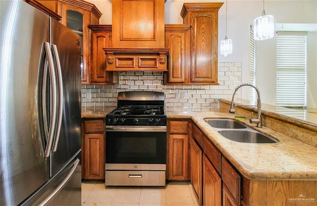 5605 N 41st St, Mcallen, TX 78504 - kitchen featuring stainless steel appliances, a sink, brown cabinetry, and light stone counters