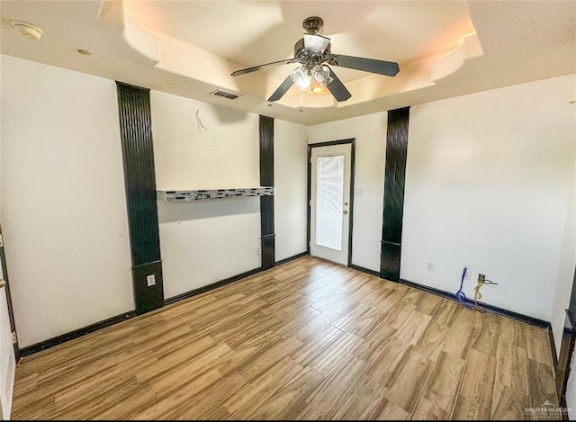 5605 N 41st St, Mcallen, TX 78504 - spare room featuring a tray ceiling, wood finished floors, and ceiling fan