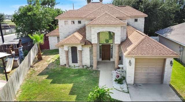 5605 N 41st St, Mcallen, TX 78504 - view of front facade with brick siding, a garage, roof with shingles, and driveway