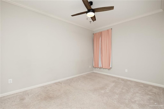 spare room featuring ceiling fan, ornamental molding, carpet flooring, and baseboards