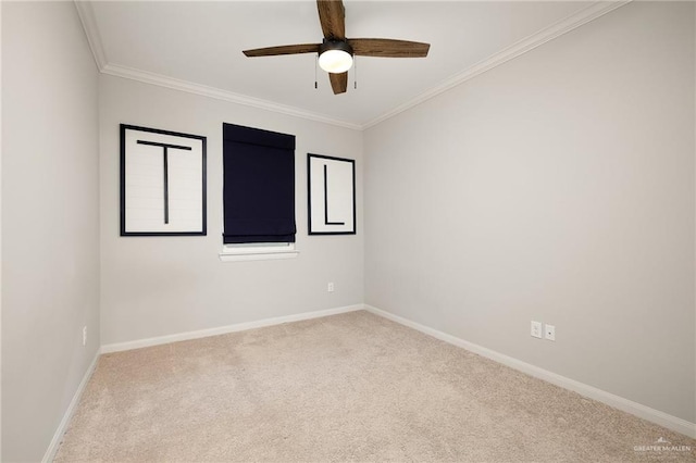 unfurnished room featuring carpet floors, ornamental molding, a ceiling fan, and baseboards