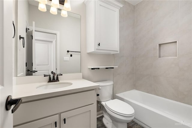 bathroom with toilet, bathtub / shower combination, and vanity