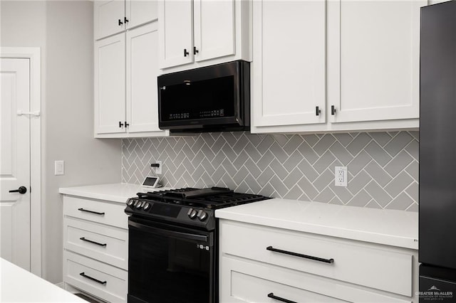 kitchen featuring black appliances, light countertops, white cabinets, and decorative backsplash