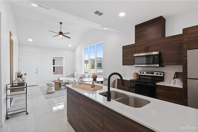 kitchen with visible vents, modern cabinets, a sink, appliances with stainless steel finishes, and light countertops