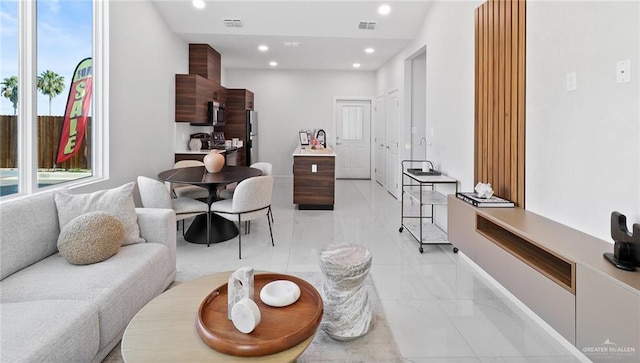 living area featuring recessed lighting, visible vents, and marble finish floor