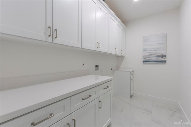 5703 N 44th Ln, Mcallen, TX 78504 - washroom featuring cabinet space, hookup for a washing machine, and light marble finish flooring
