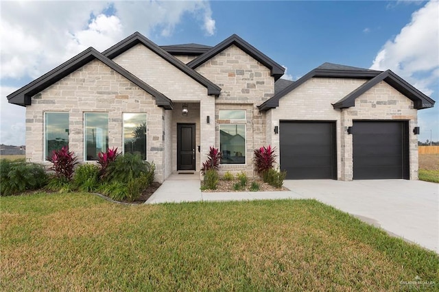 5703 N 44th Ln, Mcallen, TX 78504 - french country style house with a garage, driveway, a front lawn, and stone siding