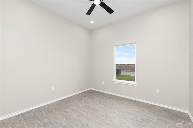 spare room with light wood-type flooring and ceiling fan