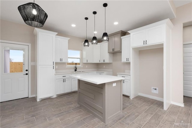 kitchen featuring white cabinetry, a center island, and decorative light fixtures