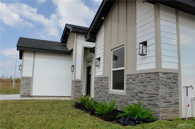 view of side of home featuring a lawn