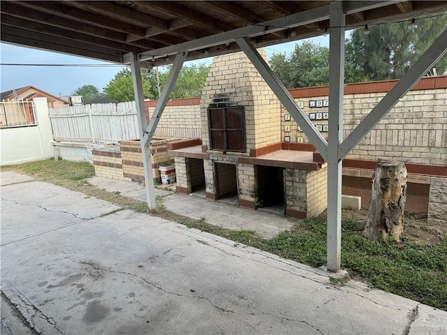 view of patio with a fireplace