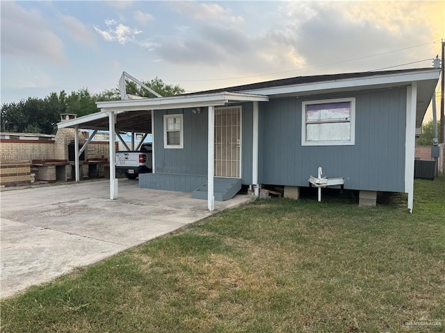 exterior space with a front lawn and a carport