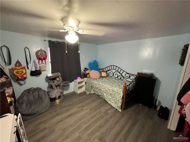 bedroom featuring hardwood / wood-style flooring and ceiling fan