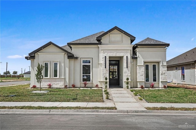 view of front of property with a front lawn and stucco siding