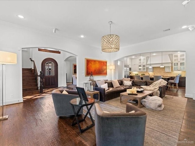 7 Ivy Ct, Spring, TX 77382 - living room with arched walkways, stairway, crown molding, recessed lighting, and wood finished floors