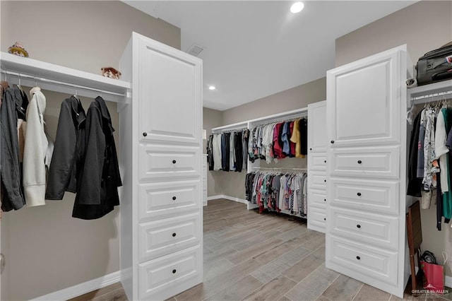 spacious closet featuring light hardwood / wood-style floors