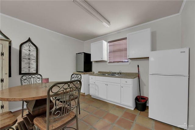 kitchen with stainless steel fridge, crown molding, sink, white fridge, and white cabinetry