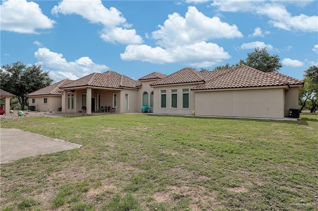 rear view of house featuring a yard