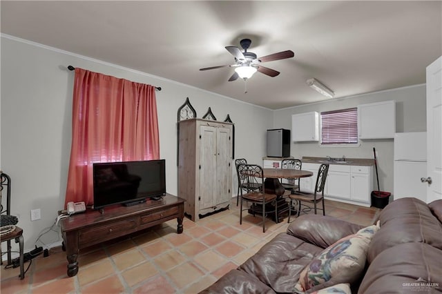 living room with ceiling fan, light tile patterned flooring, sink, and crown molding