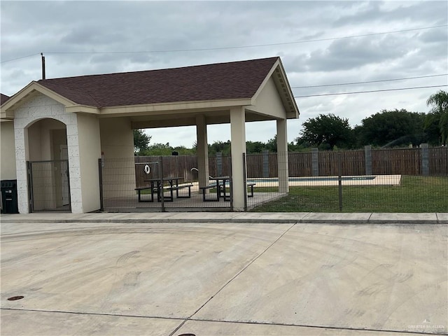 surrounding community with fence and a swimming pool