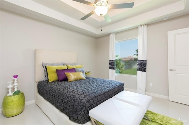 tiled bedroom with baseboards and ceiling fan