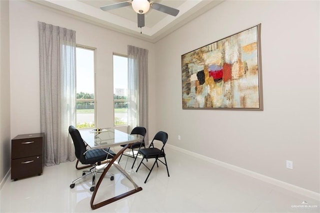 office space featuring baseboards and ceiling fan