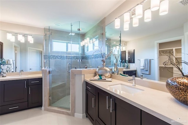 bathroom featuring two vanities, visible vents, a sink, and a stall shower