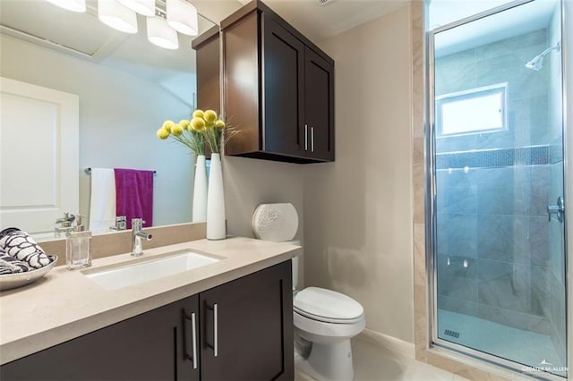 bathroom with toilet, vanity, and a stall shower