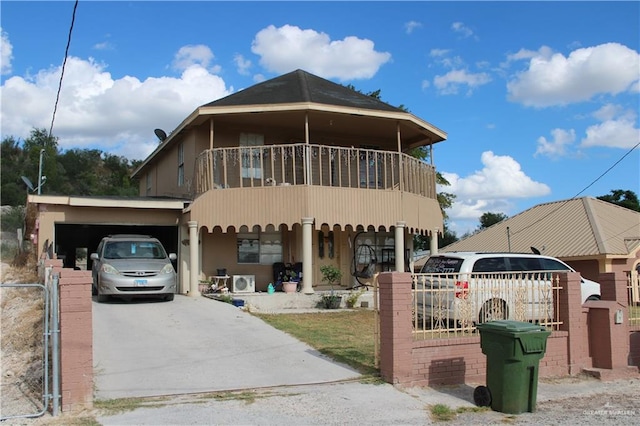 view of front of home featuring covered porch, a balcony, and a carport