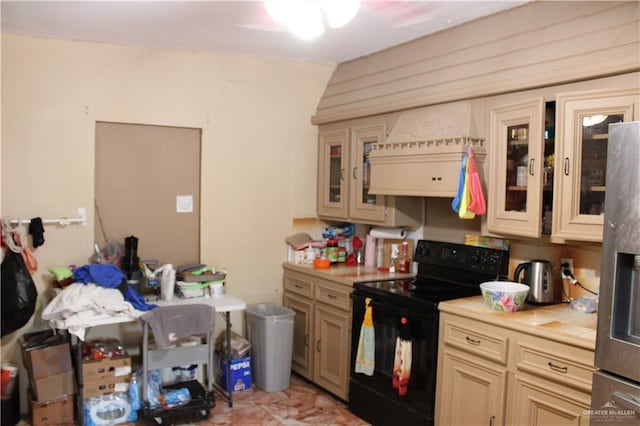 kitchen with black electric range oven, custom range hood, stainless steel refrigerator with ice dispenser, and light tile patterned floors