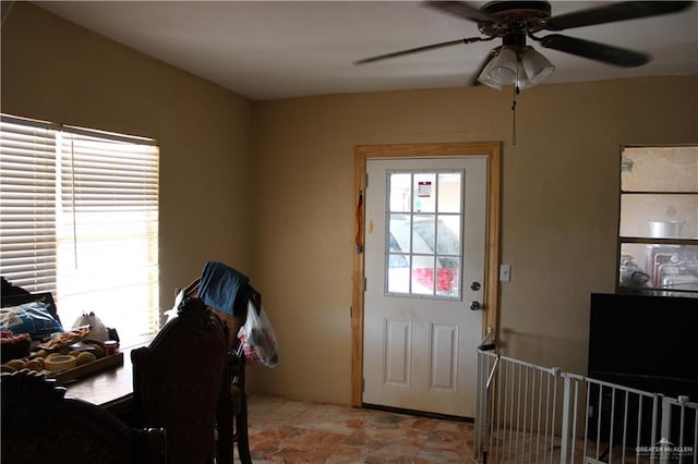 doorway featuring ceiling fan