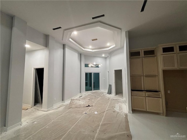 hallway featuring a tray ceiling