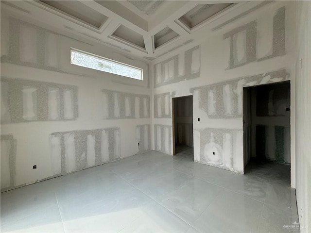 spare room with beamed ceiling and coffered ceiling