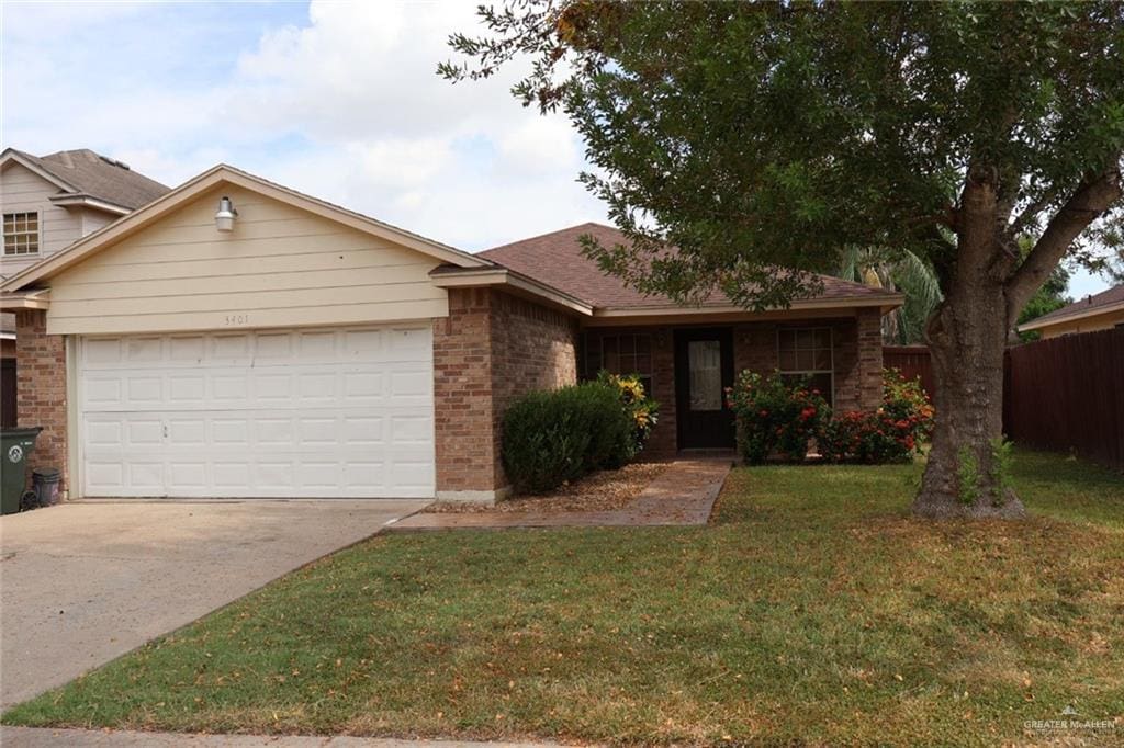 single story home with a front yard and a garage