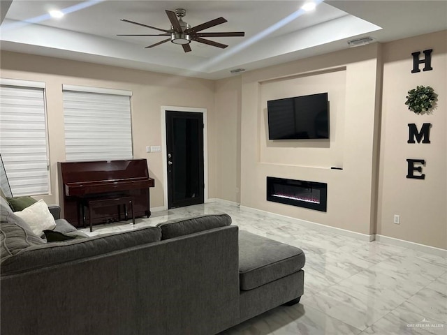 2429 Summer Breeze St, Mission, TX 78574 - living room featuring a tray ceiling, visible vents, ceiling fan, a glass covered fireplace, and marble finish floor