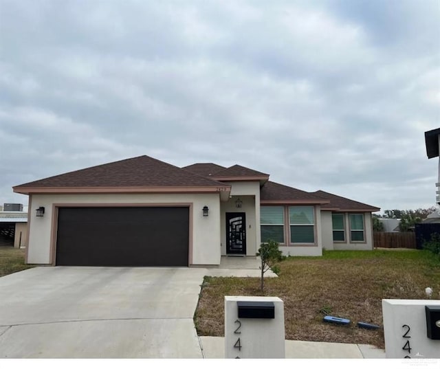 2429 Summer Breeze St, Mission, TX 78574 - prairie-style home with stucco siding, driveway, a garage, and roof with shingles