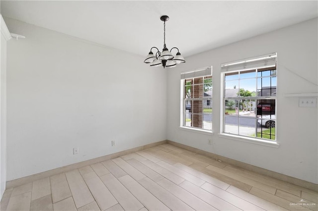 2216 Fairmont Ave, Mcallen, TX 78504 - unfurnished room with a chandelier and light wood-style flooring