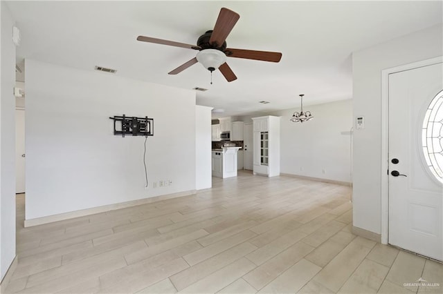 2216 Fairmont Ave, Mcallen, TX 78504 - entryway featuring a ceiling fan, light wood finished floors, and a chandelier