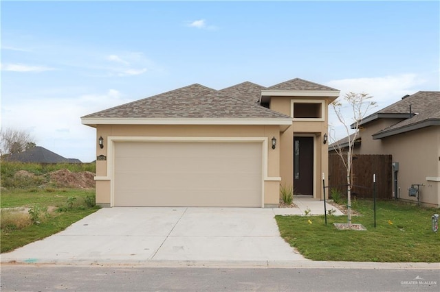 view of front of home featuring a garage and a front yard