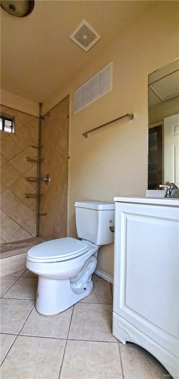 bathroom with tile patterned floors, vanity, and toilet