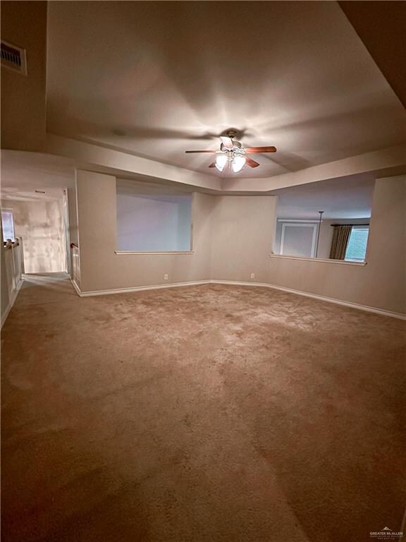 carpeted spare room with ceiling fan