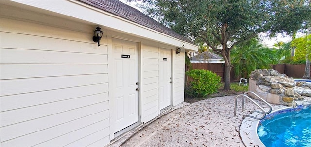 entrance to property with a patio and a fenced in pool